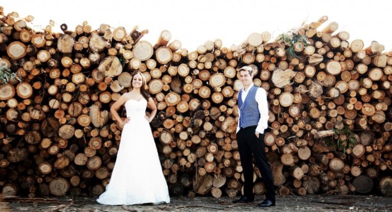 Wedding couple posing with trunks in the background